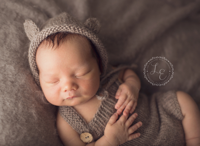 infant wearing bear outfit