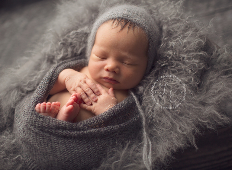 sweet baby boy wrapped in grey