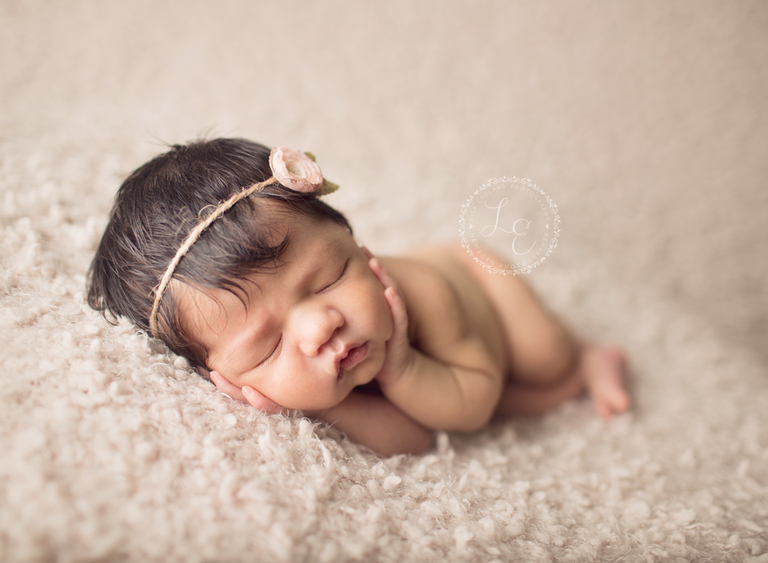 sweet baby girl chin in hands pose