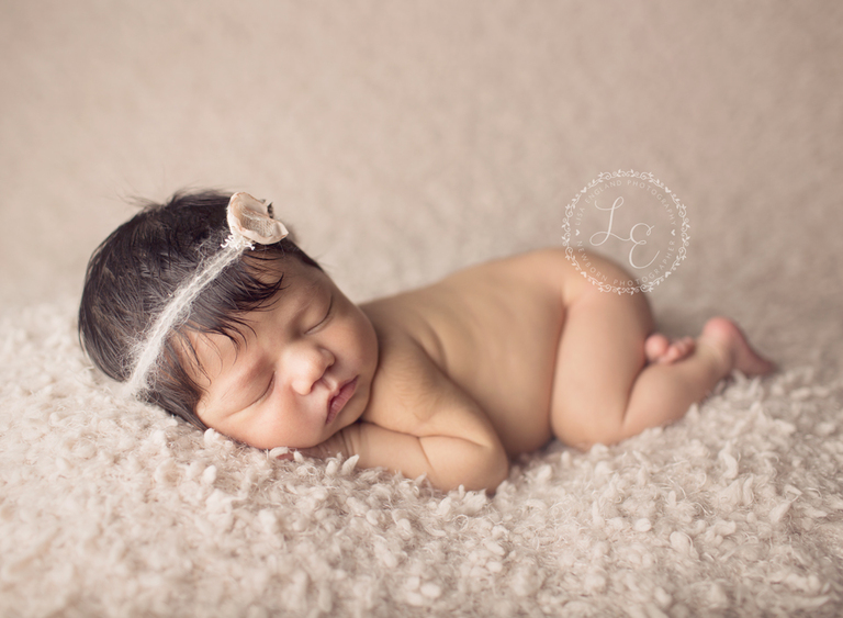 newborn girl cozy on blanket
