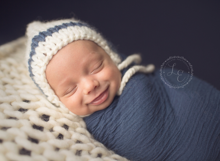 Smiling infant boy in blue 