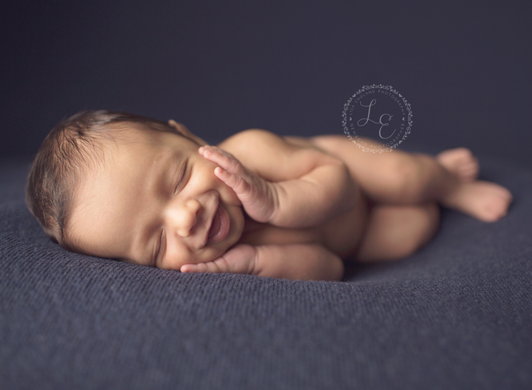 Baby boy with chin in hands