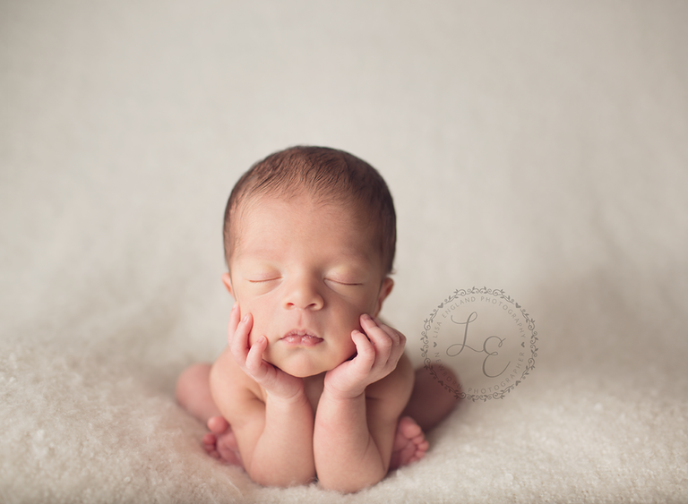 baby with chin in hands