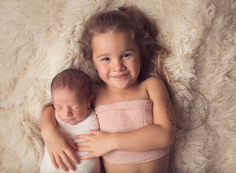 big sister with her new baby brother