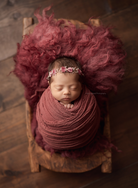 beautiful baby girl wrapped sleeping in a trencher bowl