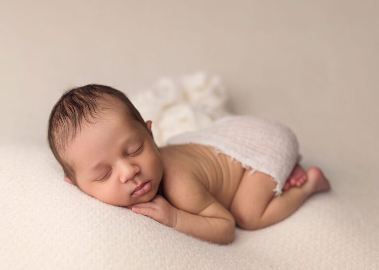 sleeping newborn posed comfortably during his San Diego newborn photo session.