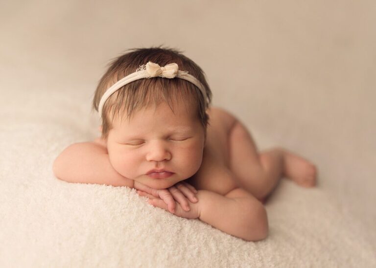 newborn girl sleeping on a soft cream blanket, san diego newborn photography studio