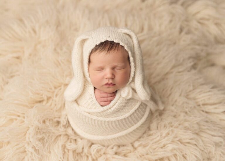 newborn baby girl wrapped in cream wearing a bunny bonnet, san diego newborn photography studio