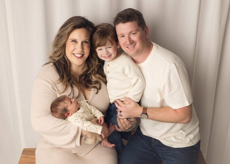 family of four posed with their new baby girl, san diego newborn photography studio