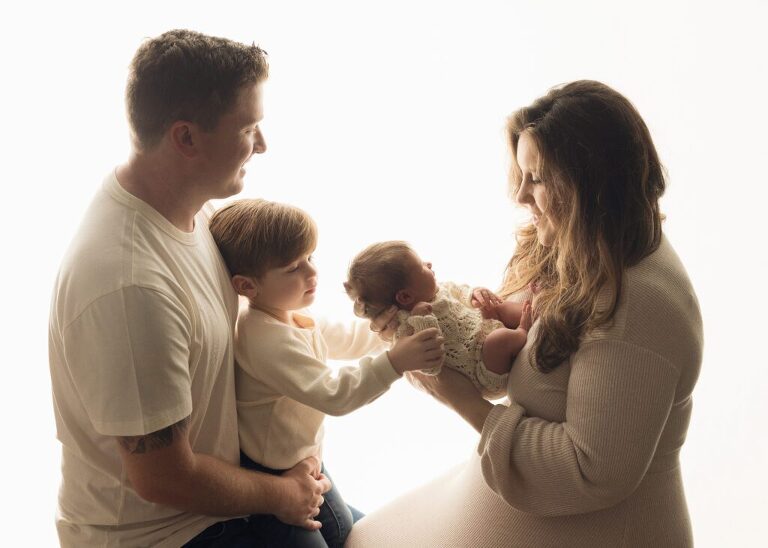 beautiful backlit family photo with newborn and proud big brother, san diego newborn photography studio