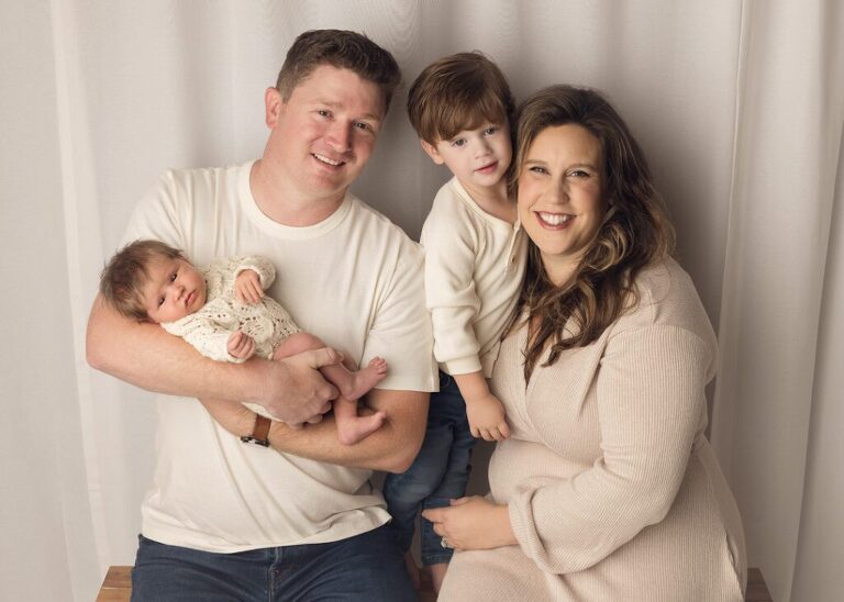 sweet family posed with their new baby girl, san diego newborn photography studio