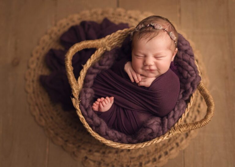 sleeping baby girl in a vibrant purple tones and textures