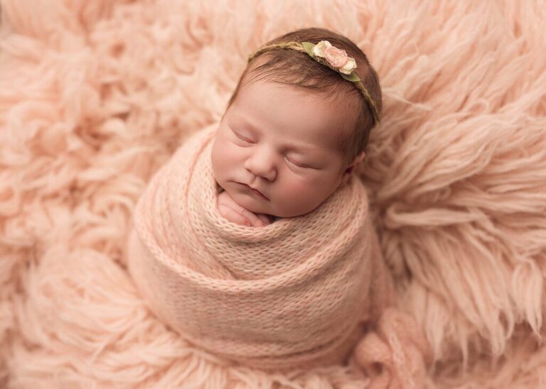 baby girl sleeping in a soft wrap during her photo session with Lisa England Photography